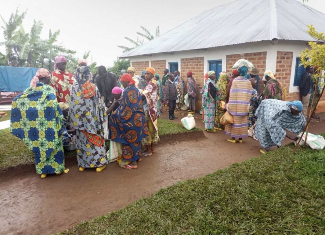 Women and community members gathered outside a building